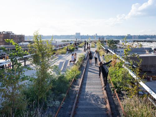 People walking and balancing on railways